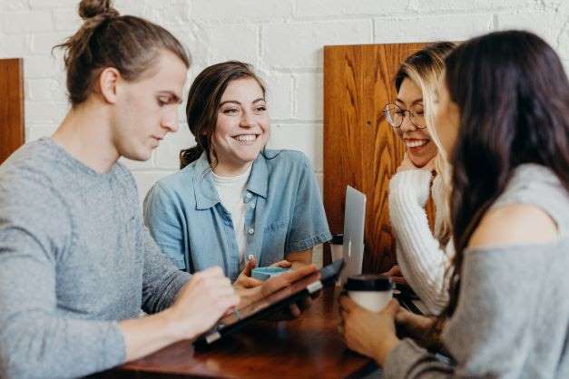 Students sitting at a table and talking