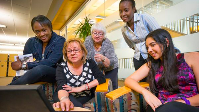 Group of women using a laptop