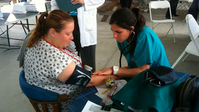 Nurse helping a patient outdoors