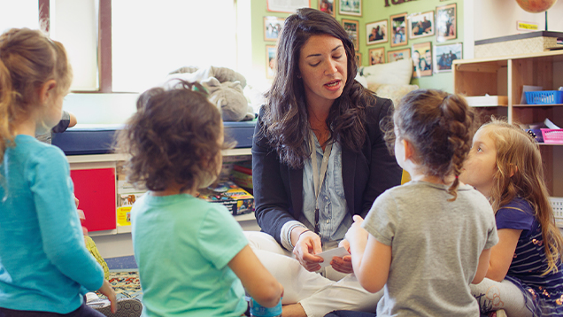 Teacher talking to children in a classroom