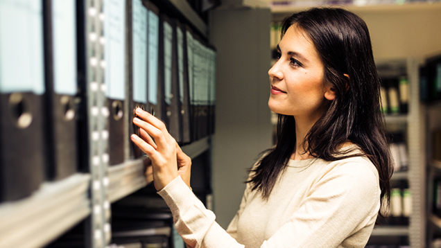 Woman searching for documents in the archives
