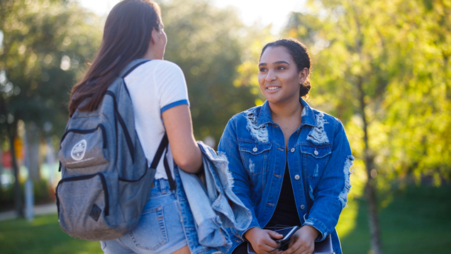 Two NSU students speaking around campus outdoors