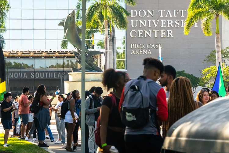 Group of students standing outside of the Don Taft University Center building