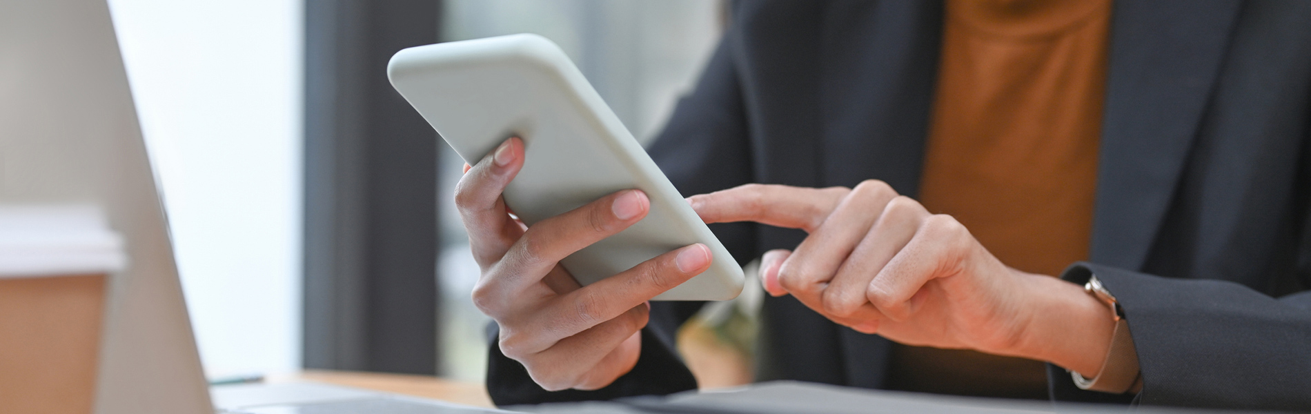 Woman using her laptop and phone close up