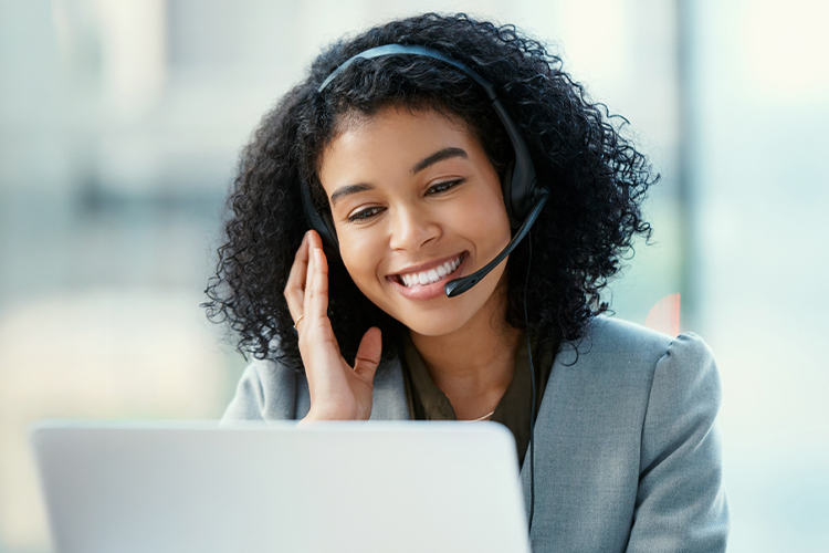 Woman using a headset and laptop in an office