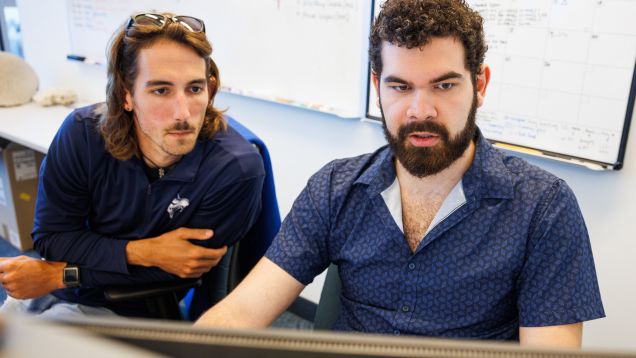 Two students collaborating at computer workstation