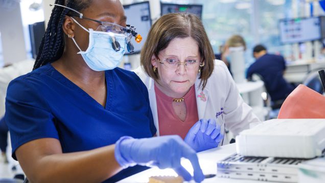 Two clinicians working together in lab