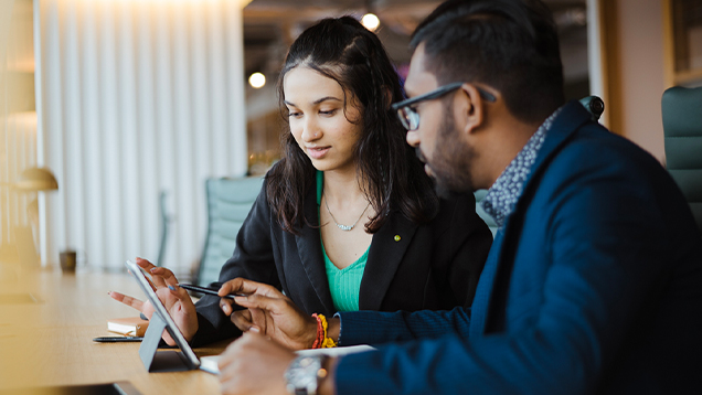 Student and her advisor looking at a digital tablet