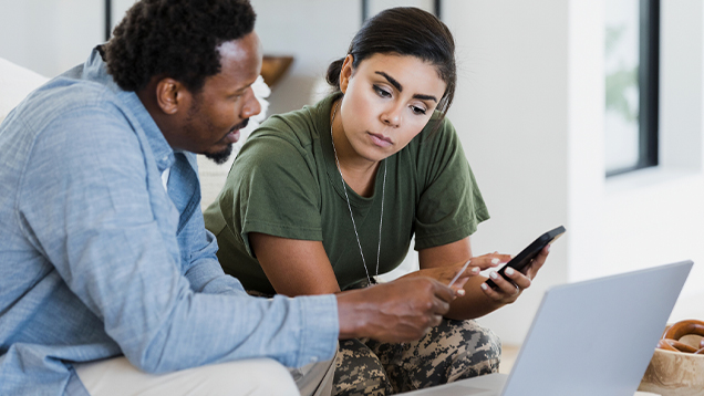 Veteran and man using a laptop