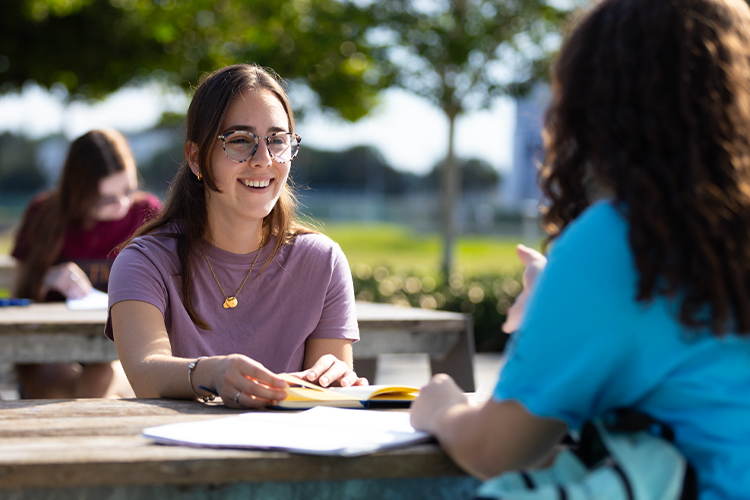 NSU students talking outside of campus