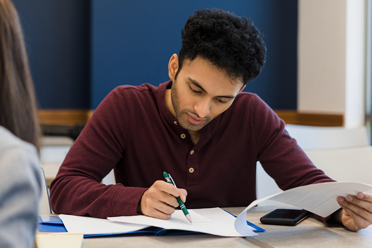 Student writing on a document