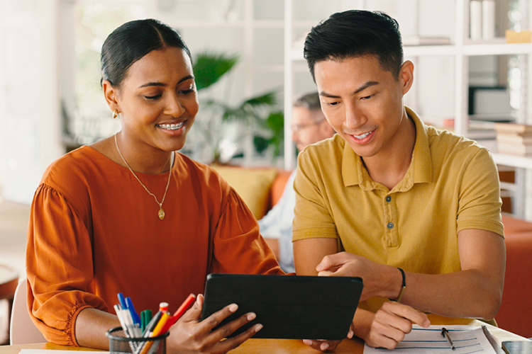 Two students using a digital tablet
