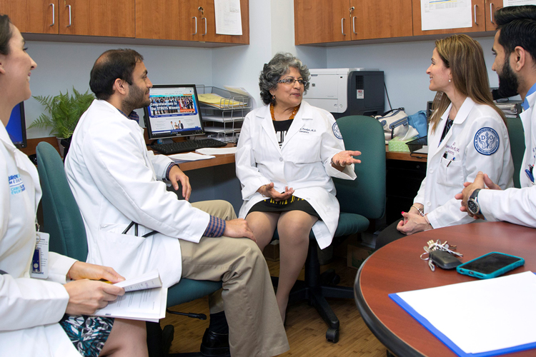 Geriatric teacher with students speaking
