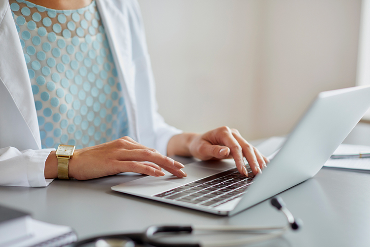Woman using her laptop in an office close up