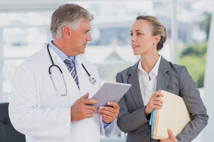 Doctor talking with a woman in an office