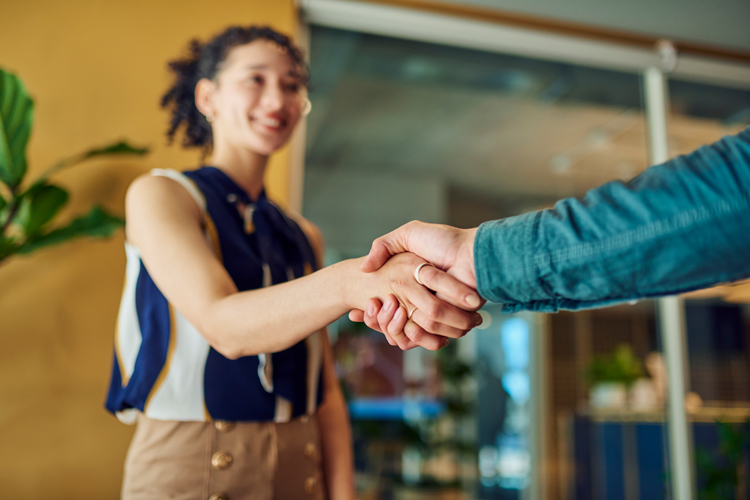Two employees walking in hallway during onboarding.