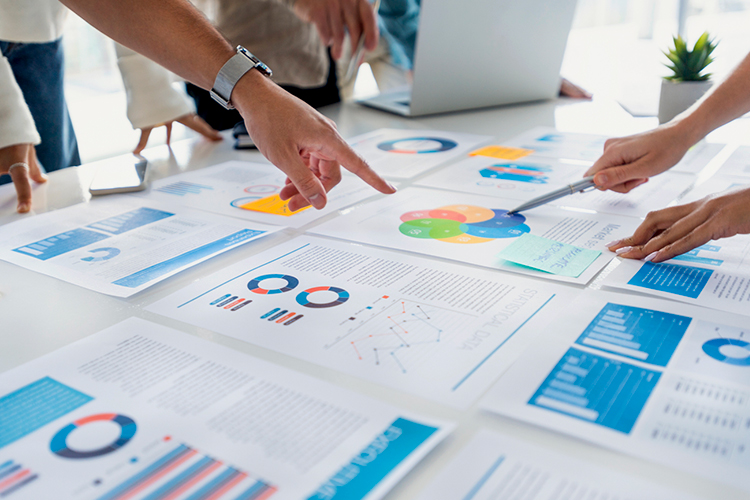 People reviewing graphs and charts in the office