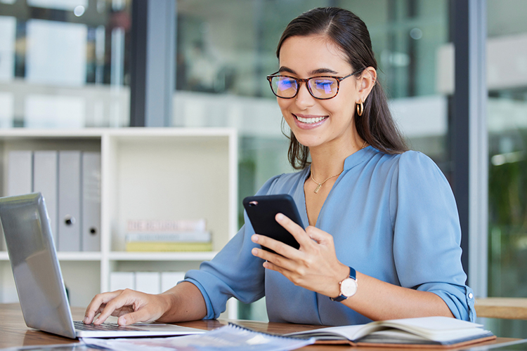 Woman using her phone in the office
