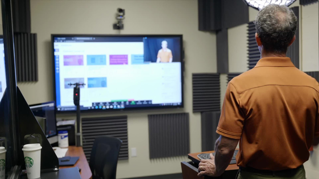 faculty in classroom using technology