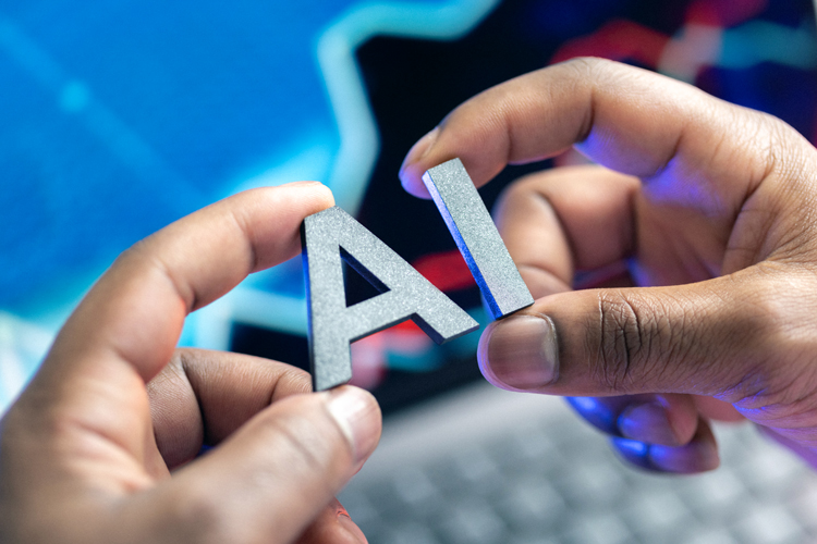 Person hands holding Ai letters