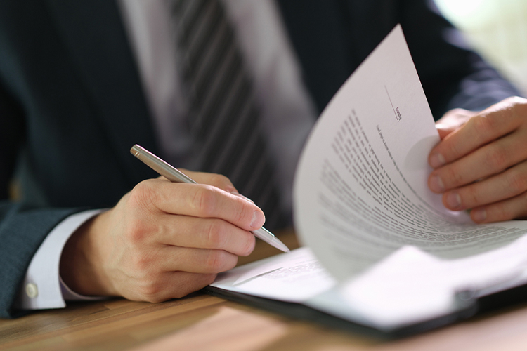 Man signing documents close up