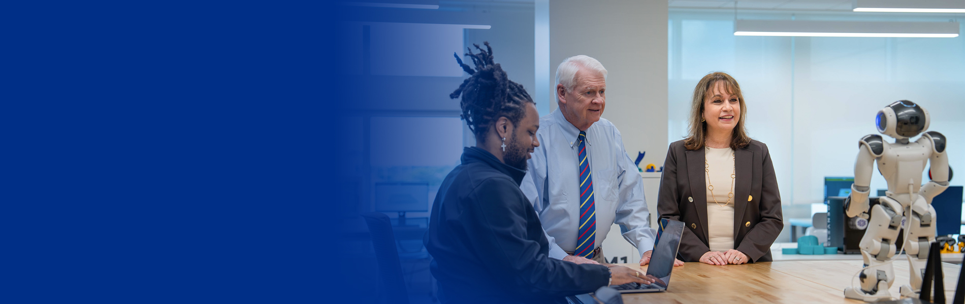 Dr. Moon looking at robots NSU innovations