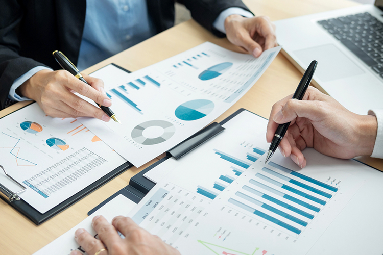 Business team reviewing charts and graphs close up