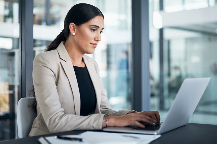 Woman using a laptop in her office