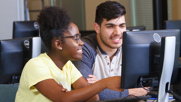 Two students using computer