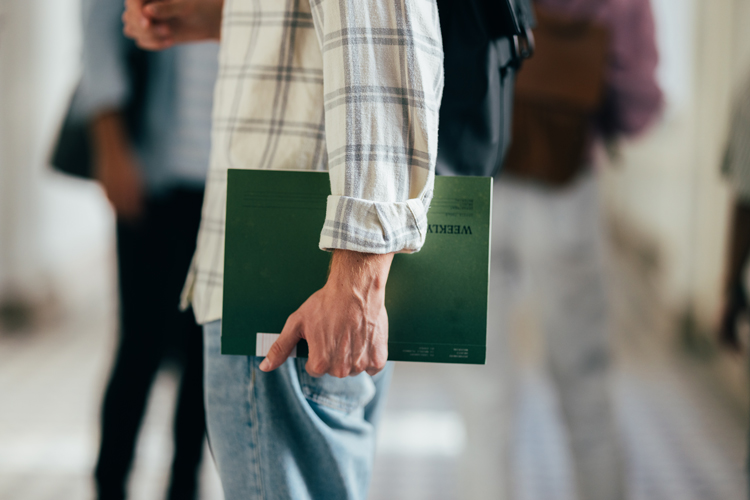 Closeup of student holding binder