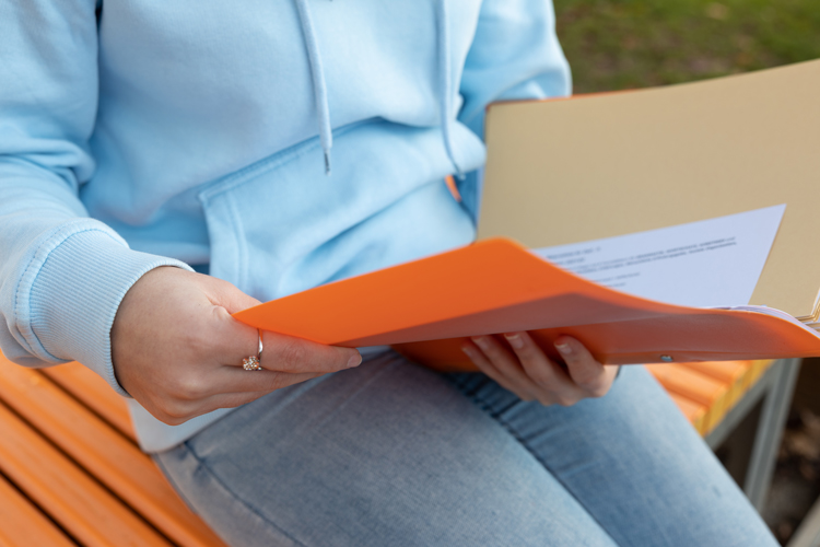 Person holding transcripts closeup
