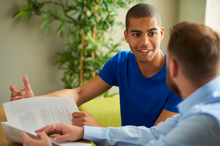 Student speaking with his adviser