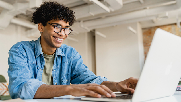 Man using a laptop in an office