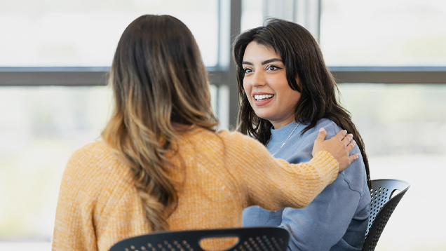 Woman smiles during a support group meeting