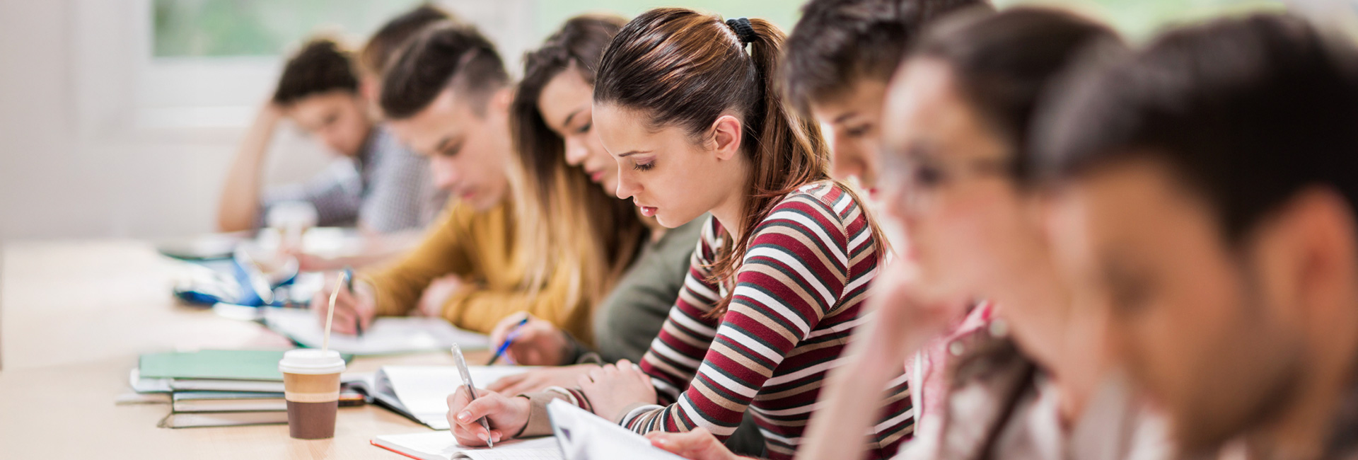 Group of students writing during a lecture in a classroom